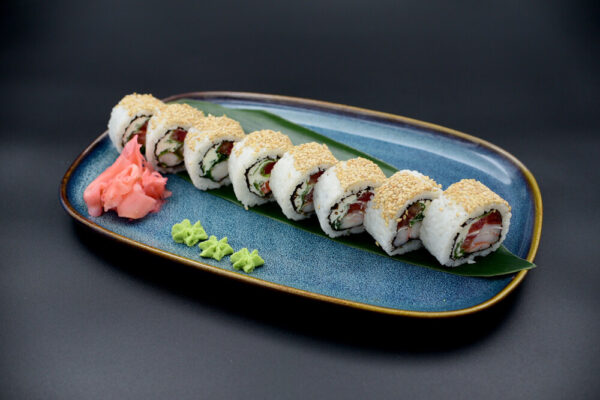 Japanese sushi roll on a blue plate.